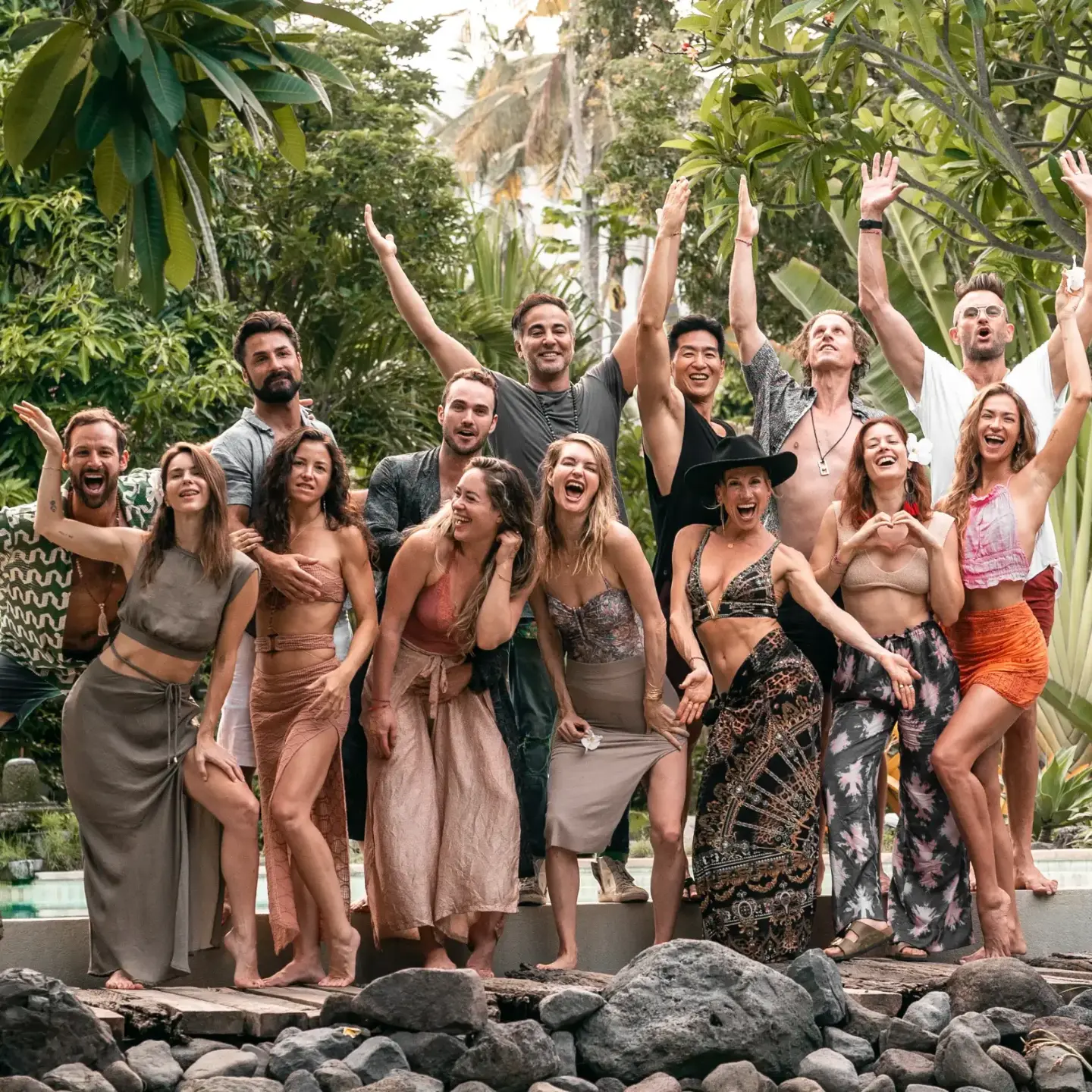 Smiling retreat group celebrating together in a garden